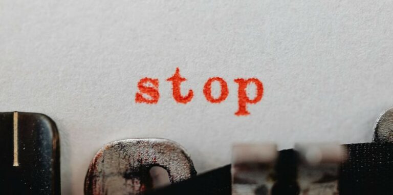 A close-up photo of a typewriter that says "stop."