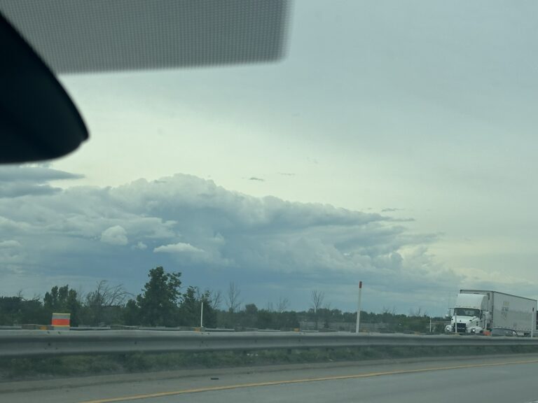 A photo of a large stormcloud taken from a freeway in Quebec.